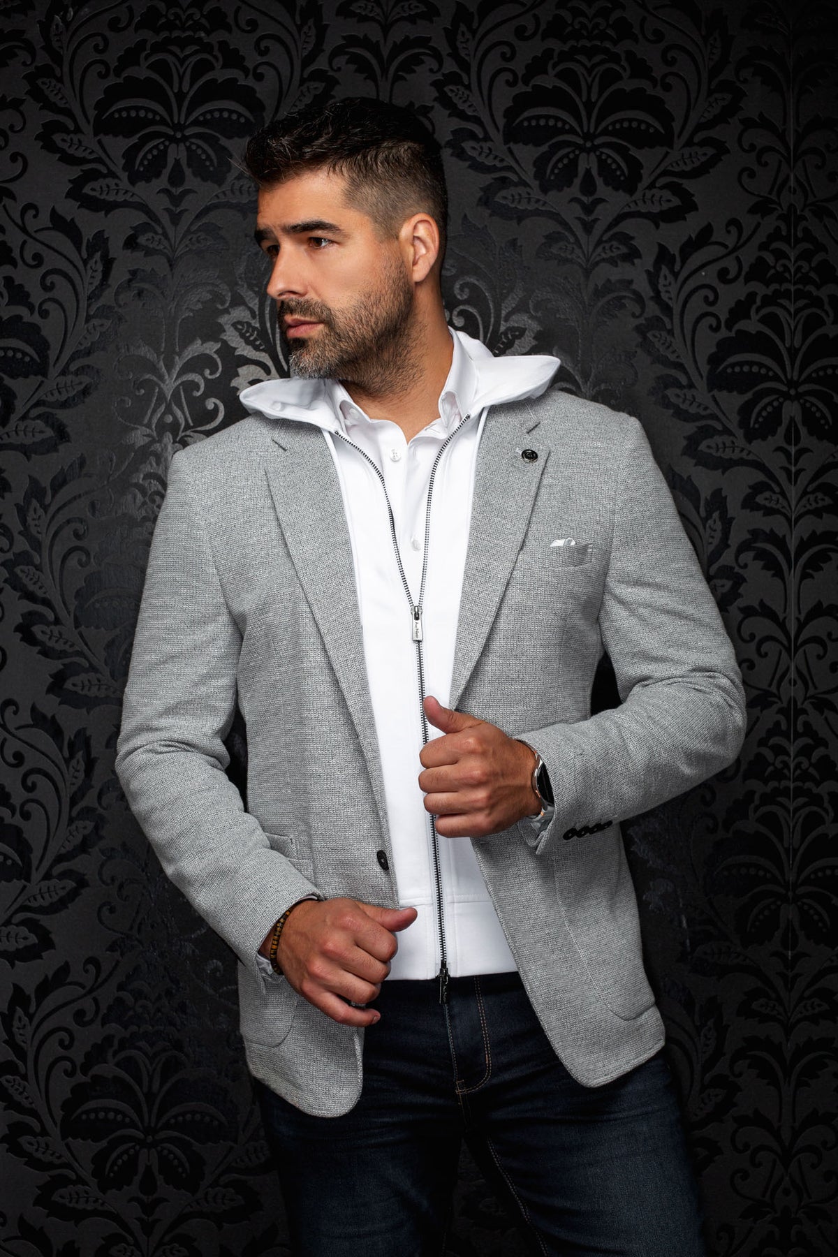 Au Noir men's light gray textured blazer with notched lapels, black buttons, and pocket square, front view