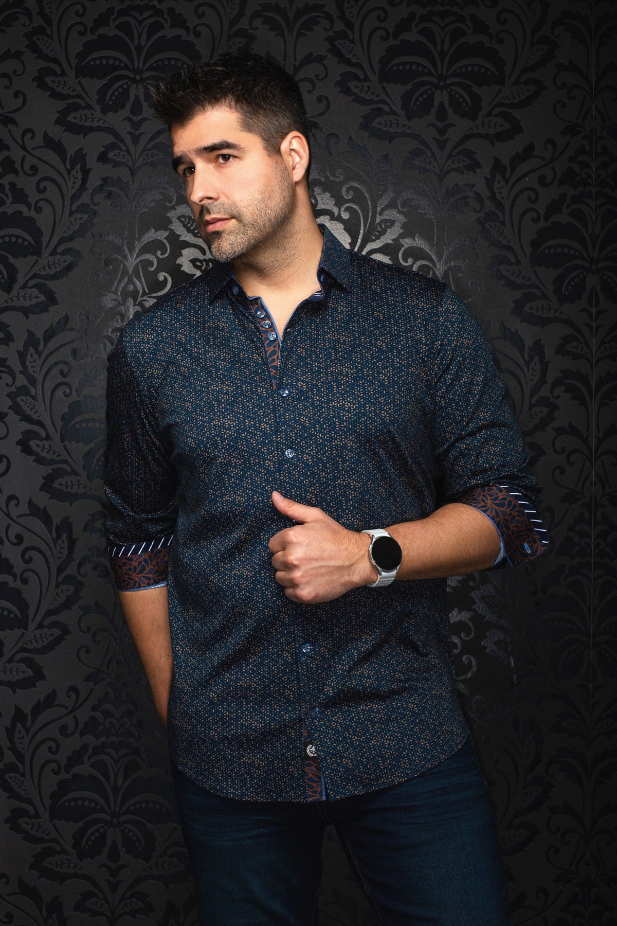 Au Noir men's navy patterned button-up shirt, angled front view with rolled cuffs and orange contrast trim