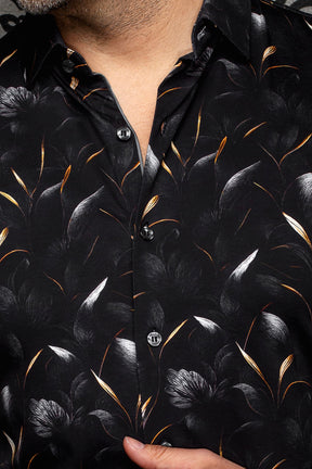 Au Noir men's black floral shirt collar, button placket, and orange and white leaf print, close-up