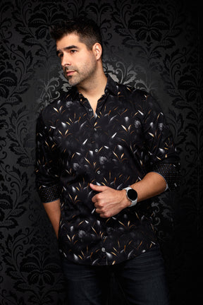 Au Noir men's angled model view of a black floral button-up shirt with rolled cuffs and orange leaf accents, side view