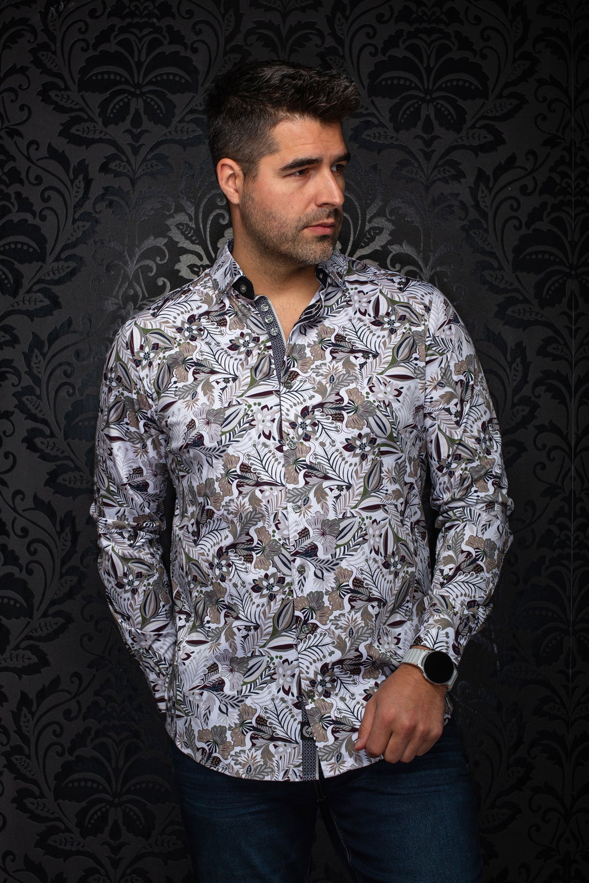 Front model view of men's white floral button-up shirt, showing the collar, cuffs and curved hem by Au Noir