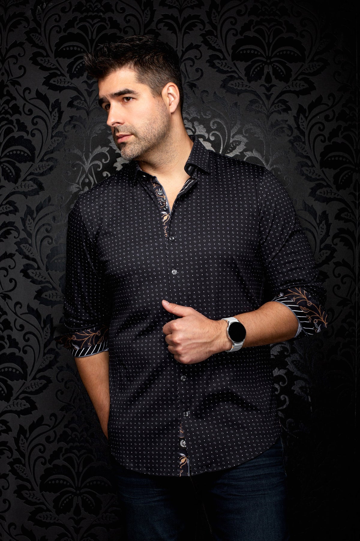 Men's black geometric print button-up shirt, front angled view with rolled cuffs showing contrast trim, side view by Au Noir