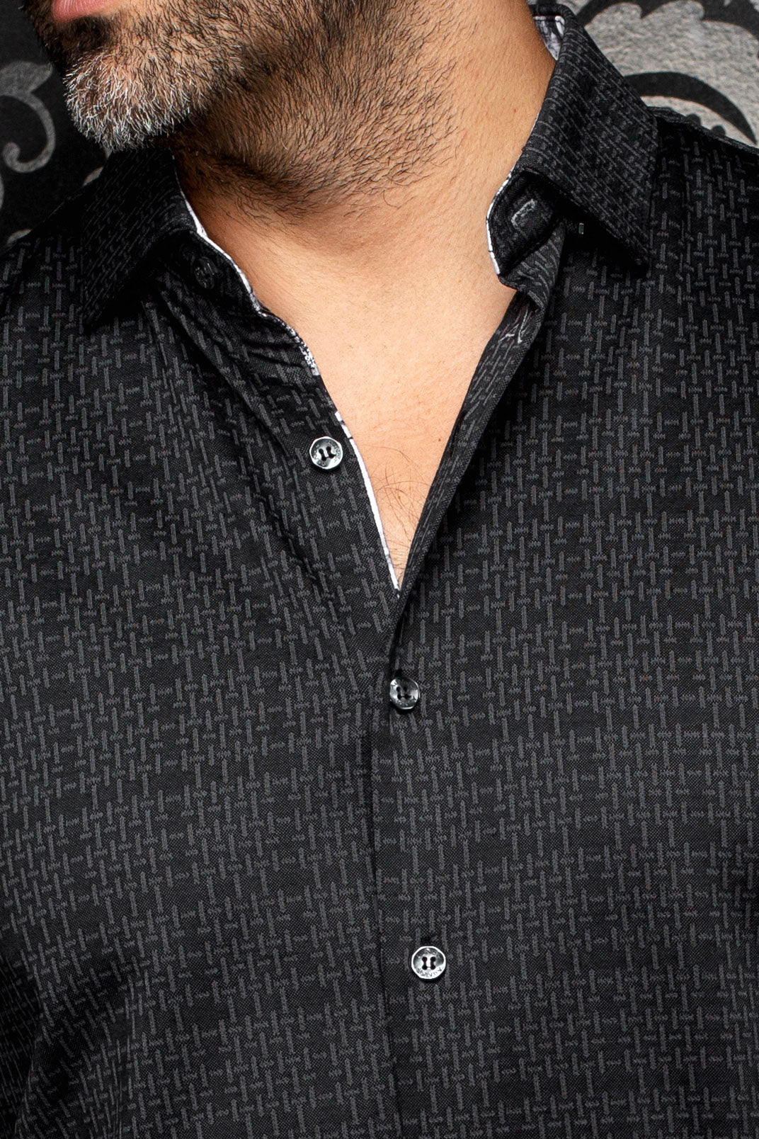 Au Noir men's black patterned button-up shirt collar, placket, buttons, and contrast trim, close view
