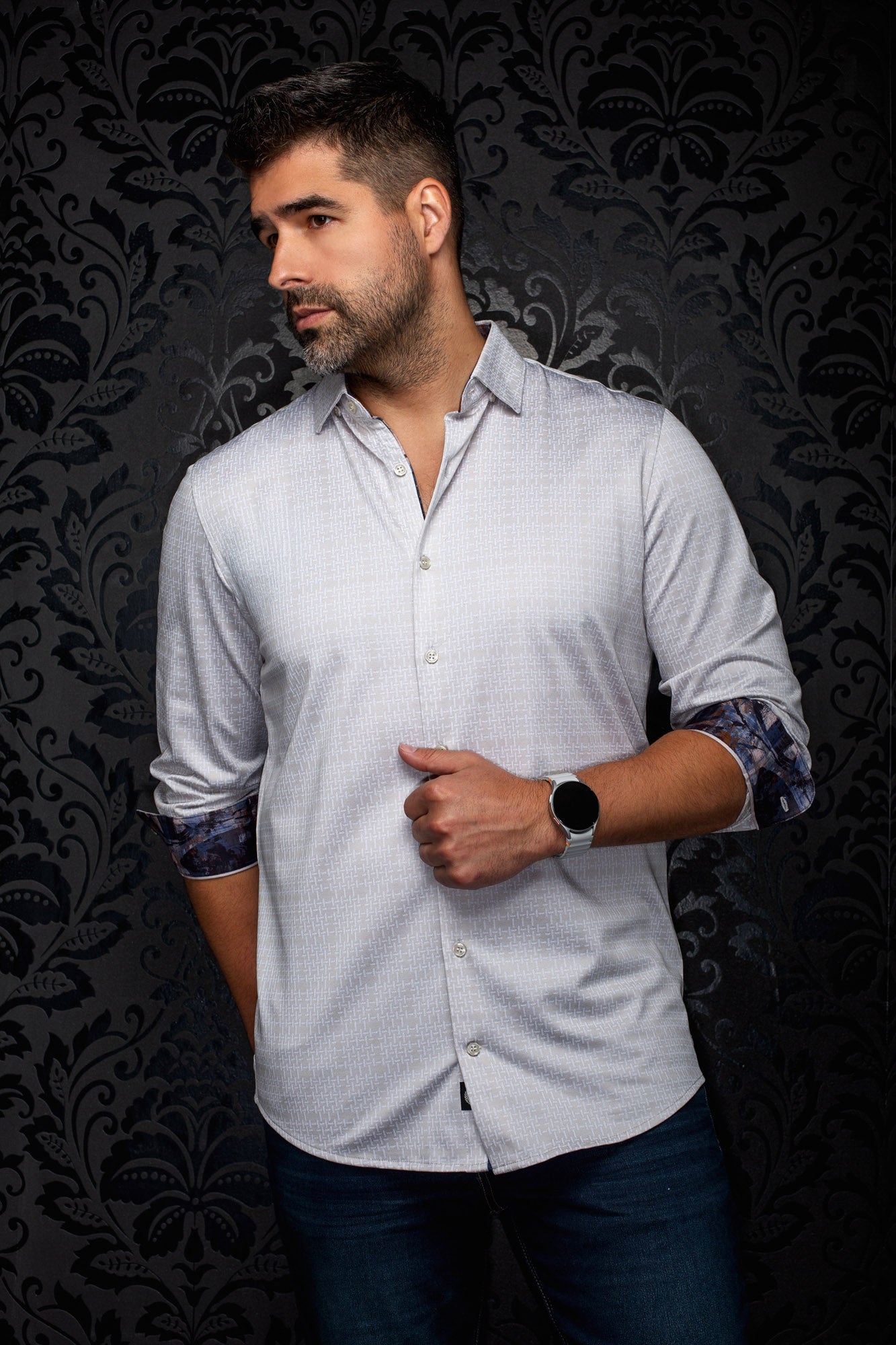Au Noir men's light gray patterned button-up shirt angled on model, sleeves rolled to show contrast cuffs, side view