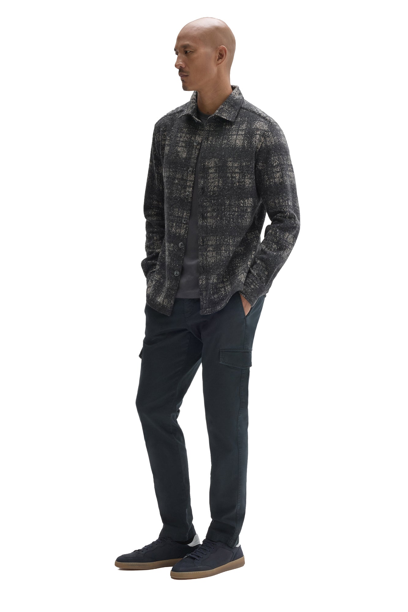Men's angled full-body view of charcoal plaid overshirt worn open over a dark T-Shirt, side view by Robert Barakett