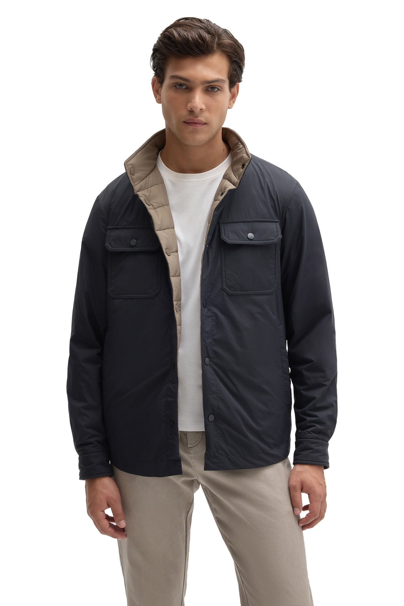 Front view of men's navy snap jacket worn open to show taupe quilted reversible interior by Robert Barakett