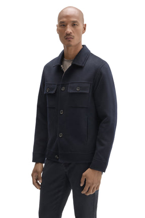 Robert Barakett men's angled front view of dark navy trucker jacket with straight hem, flap pockets and button placket