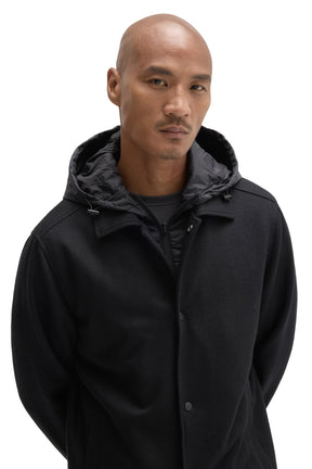 Men's close front view of black snap-front hooded jacket with charcoal nylon hood and drawcords by Robert Barakett