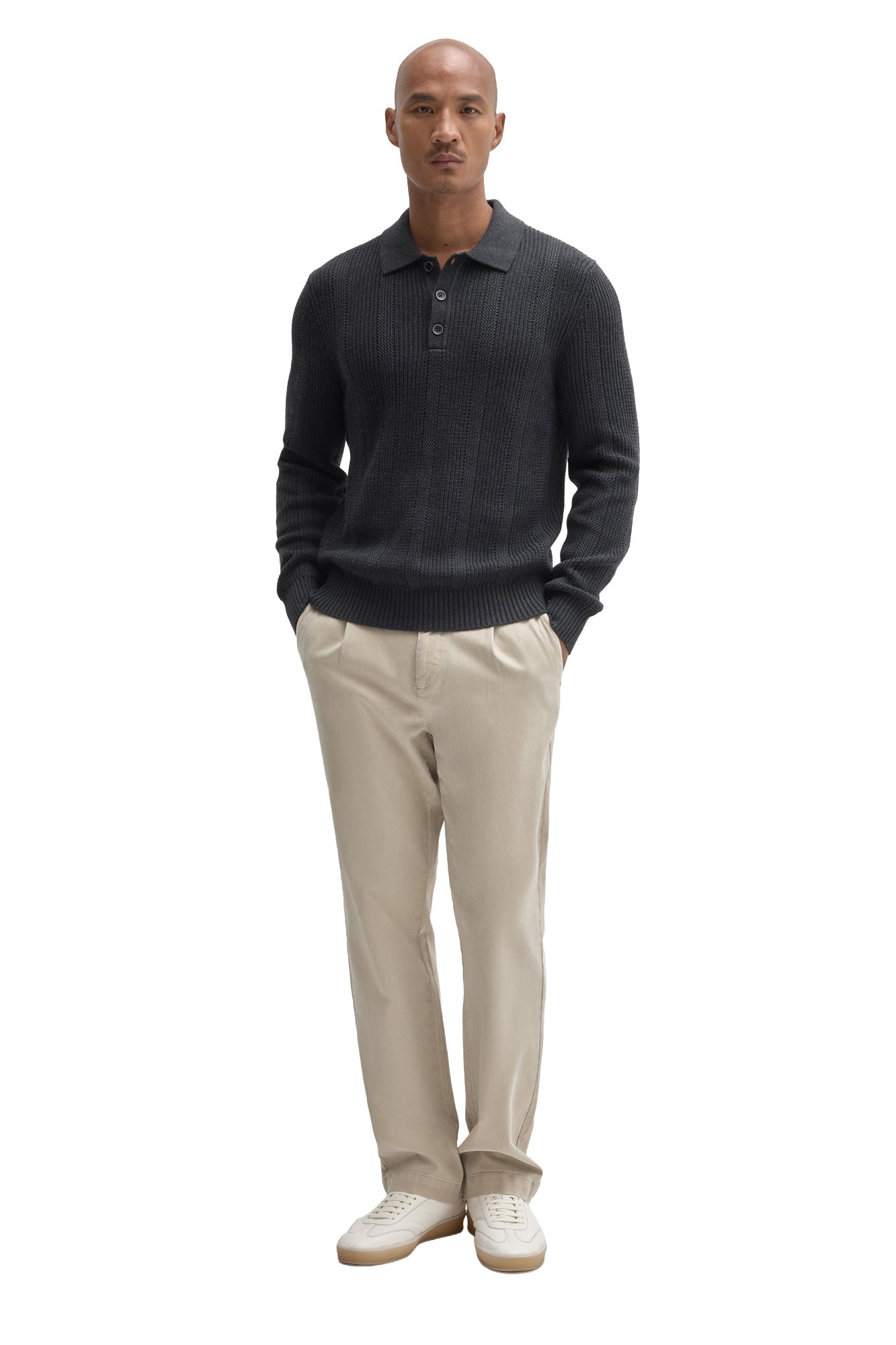 Men's full-length front view of charcoal knit long-sleeve polo styled with beige pants by Robert Barakett