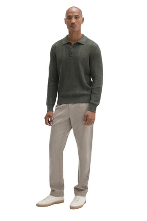 Men's full-body front view of olive green long sleeve knit polo with three-button placket and ribbed hem by Robert Barakett