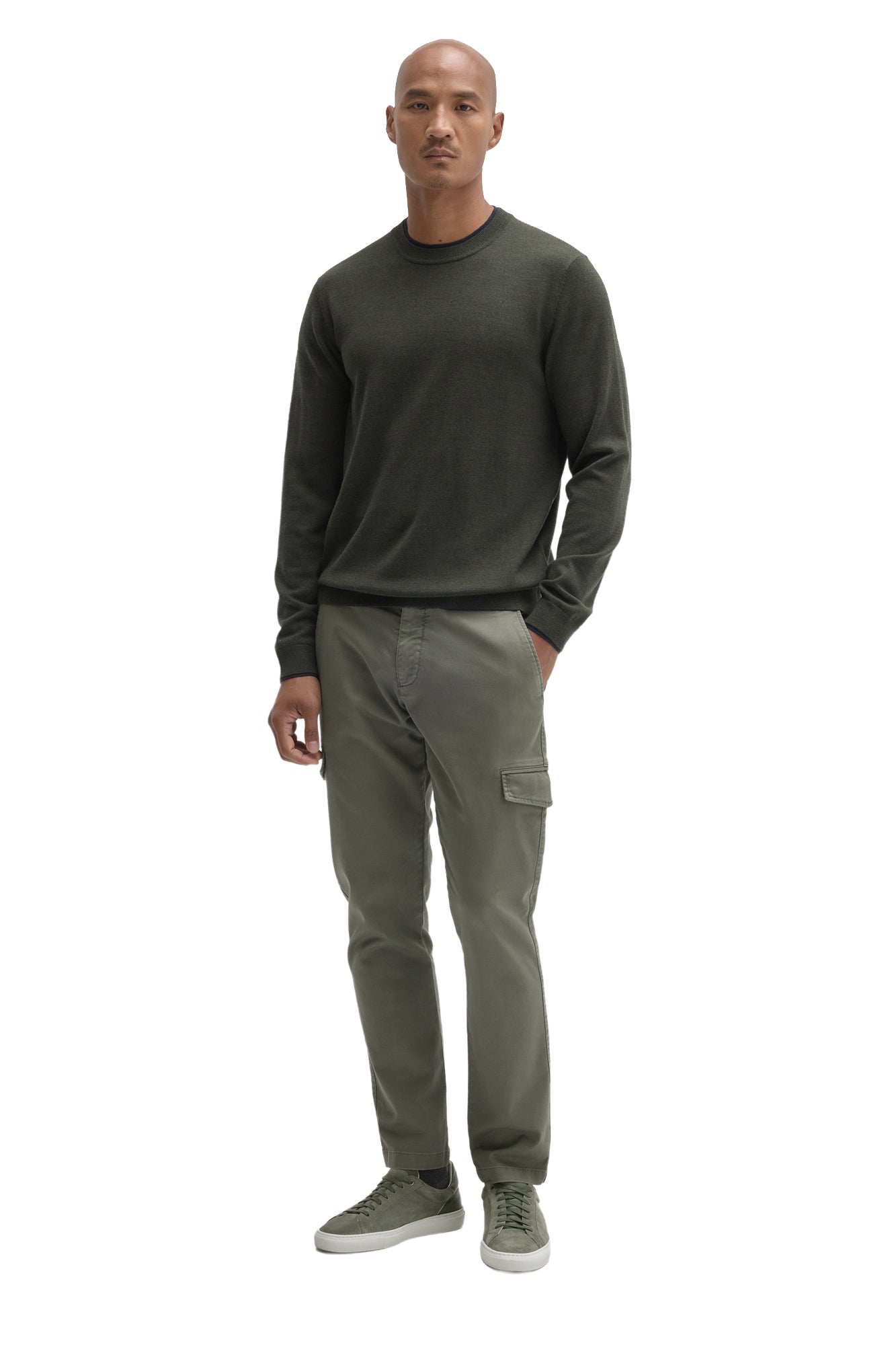 Men's full-body front view of a dark olive crew neck long-sleeve sweater styled with cargo pants by Robert Barakett