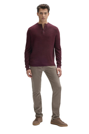 Men's full front view of burgundy long sleeve henley knit sweater styled with neutral pants by Robert Barakett