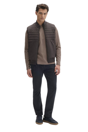Men's full front view of dark taupe quilted zip vest with ribbed trim worn over a tan top by Robert Barakett
