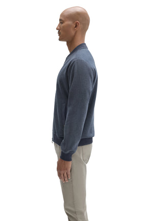 Side view of men's blue zip jacket showing side welt pocket, waistband and ribbed cuff by Robert Barakett