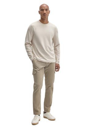 Robert Barakett men's full-body front view of an ivory long sleeve crewneck T-Shirt styled with beige pants
