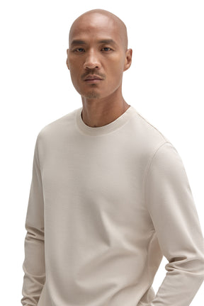 Men's close front view of an ivory long sleeve crewneck T-Shirt with fine textured surface by Robert Barakett