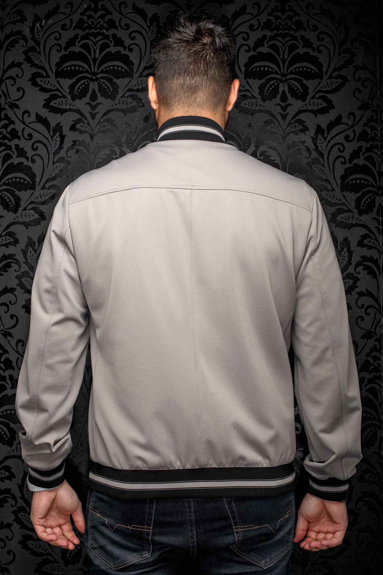 Au Noir men's gray bomber jacket back view with black ribbed striped collar, cuffs, and waistband