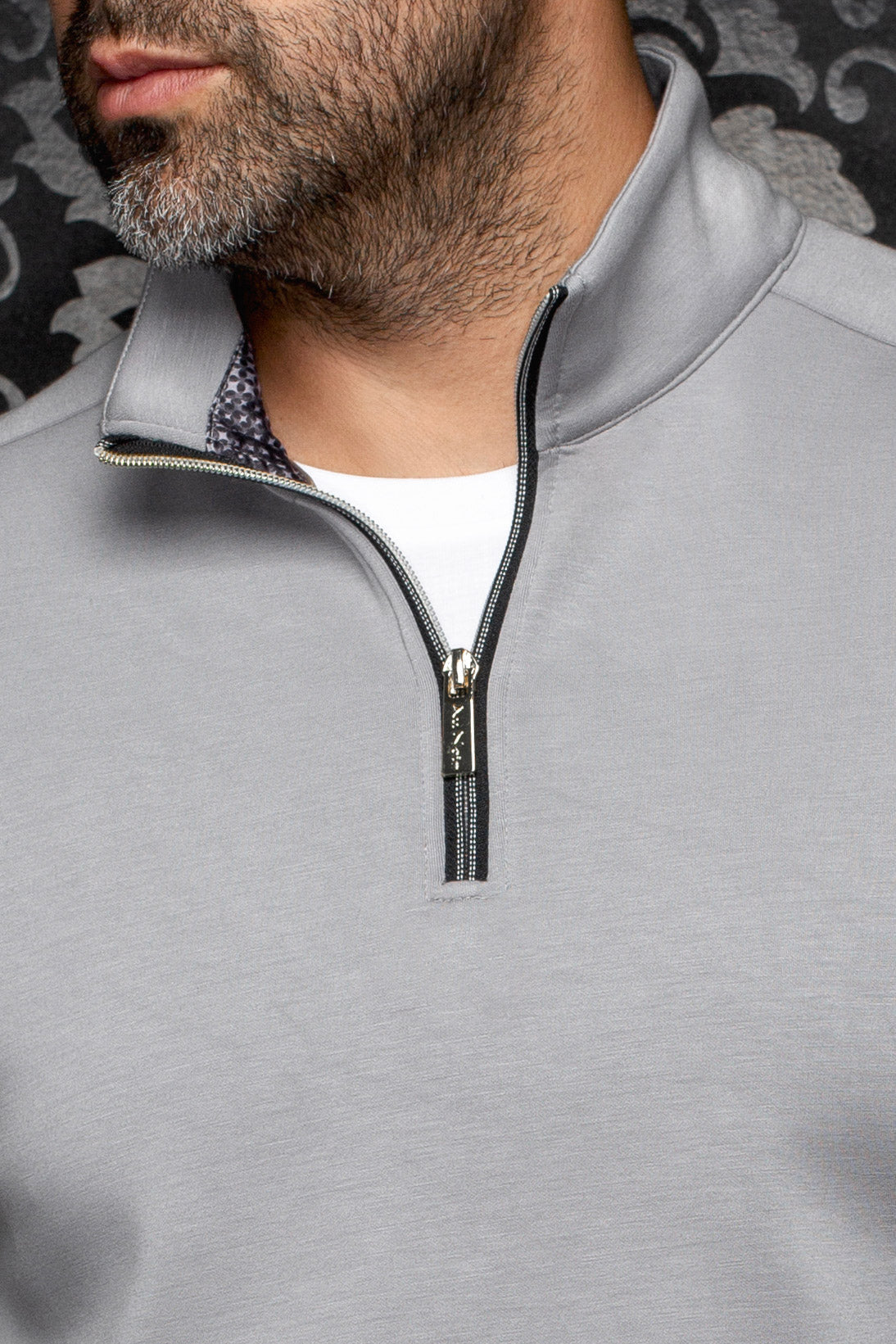 Au Noir men's collar detail of light gray quarter-zip sports jacket with black zipper and metal pull