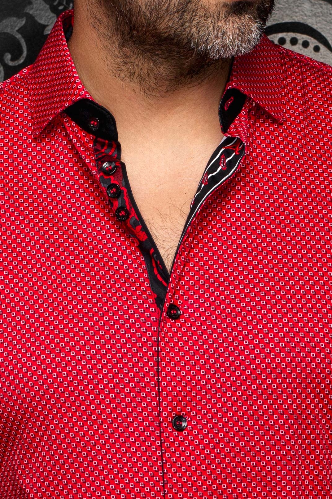 Au Noir men's red geometric print shirt collar, black placket, black buttons, and contrast trim, close-up