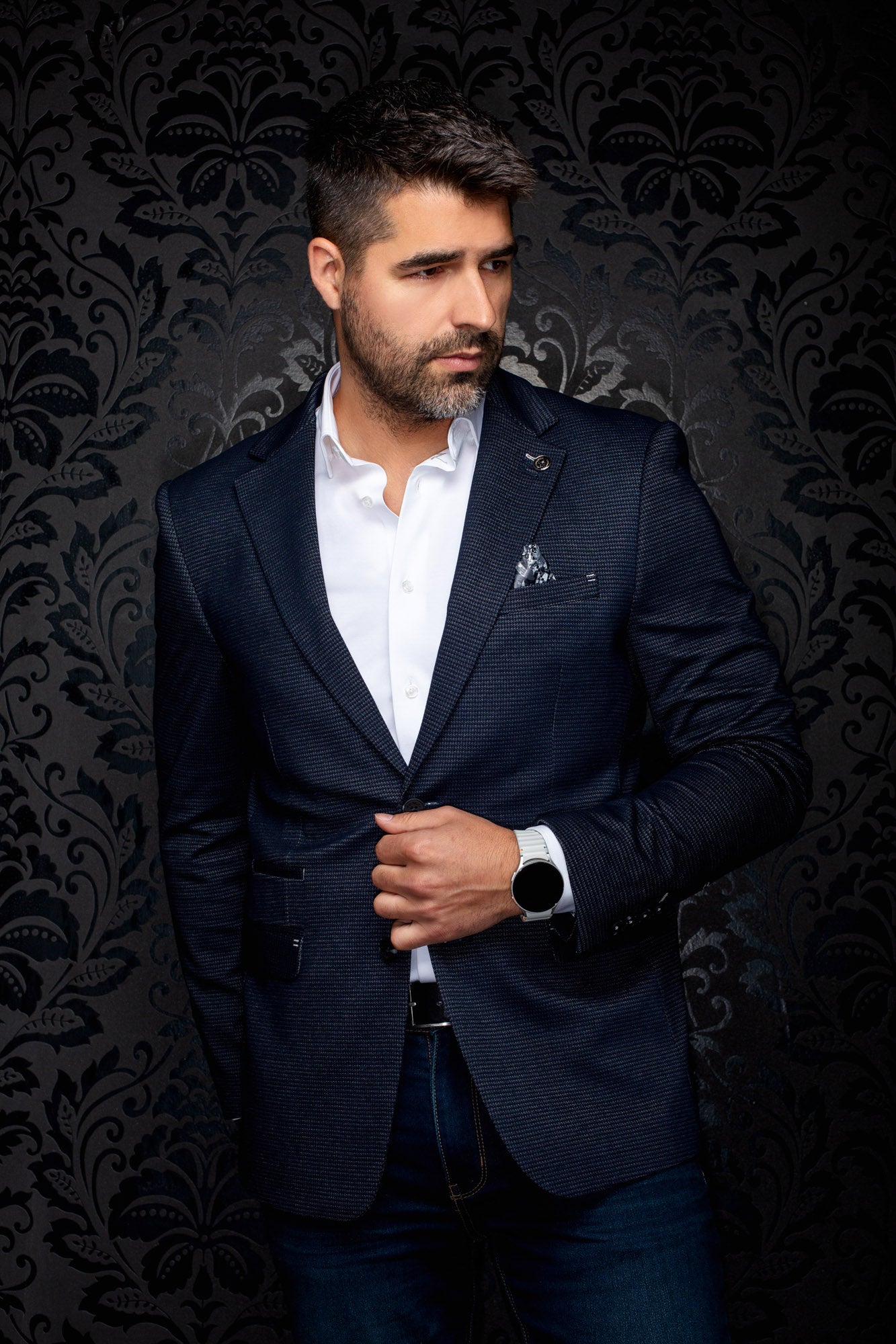 Au Noir men's navy micro-check blazer front view with notched lapels, lapel pin, and flap pockets