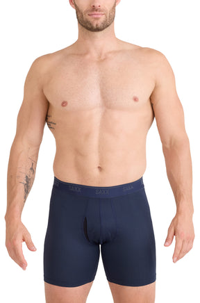 Front model view of men's navy boxer briefs with SAXX logo waistband and contoured pouch