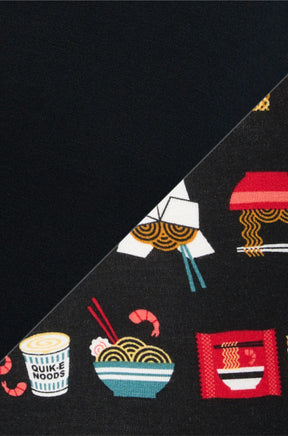 Men's fabric detail of black boxer underwear showing colorful noodle food print and solid black knit by Saxx