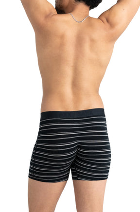 Men's black striped boxer underwear on model, back view with mid-thigh legs and black logo waistband by Saxx