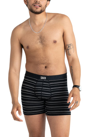front view of Saxx men's black striped boxer underwear on model with black SAXX waistband and pouch seams