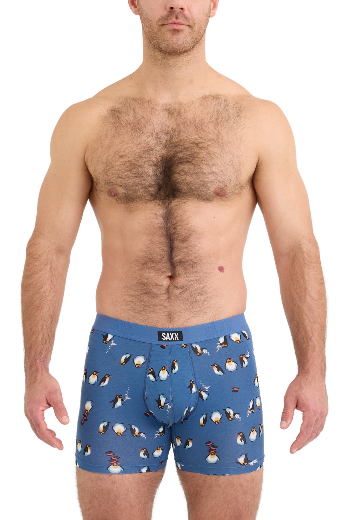 Saxx men's blue boxer underwear with blue logo waistband and penguin print shown from the front