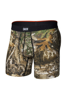 Men's brown woodland camouflage boxer underwear with pouch seams and black SAXX waistband, isolated front view