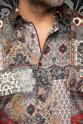 Au Noir men's multicolor paisley patchwork shirt with spread collar and burgundy buttons, close-up