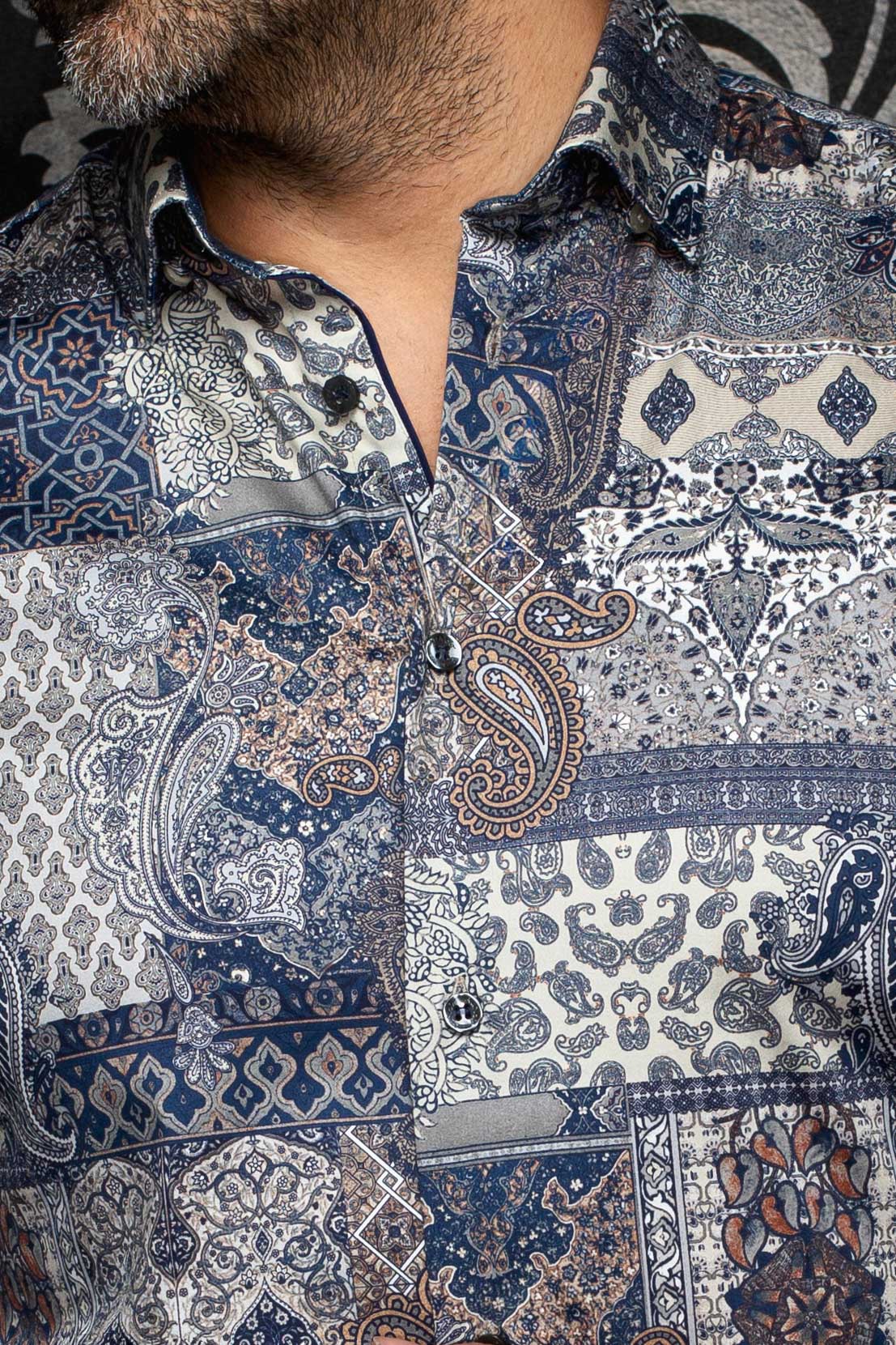 Au Noir men's navy paisley patchwork button-up shirt showing collar, placket, and dark buttons, close-up