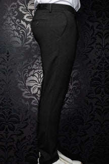 Men's black pants shown from the side, with belt loops, a back welt pocket and subtle woven texture by Au Noir